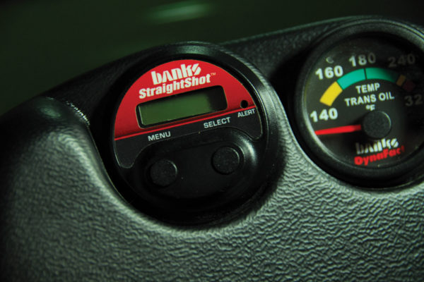 The wiring harness at the pump connects with the electronic gauge control, mounted in a housing on the dash. This unit also displays boost or throttle position sensor percentage, plus exhaust gas temp.