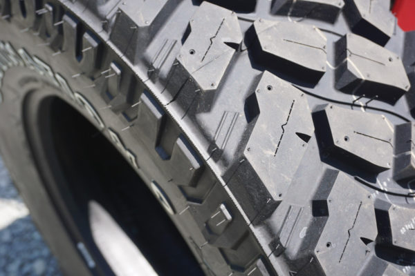 The open tread design of the Firestone Destination M/T2 allows the tread blocks to dig in and shed stones. Stone-shedding is assisted by those little ribs in between the tread blocks. Each block is sliced with a sipe to help with snow and ice traction. Finally, the little holes allow you to add metal studs for additional ice traction.
